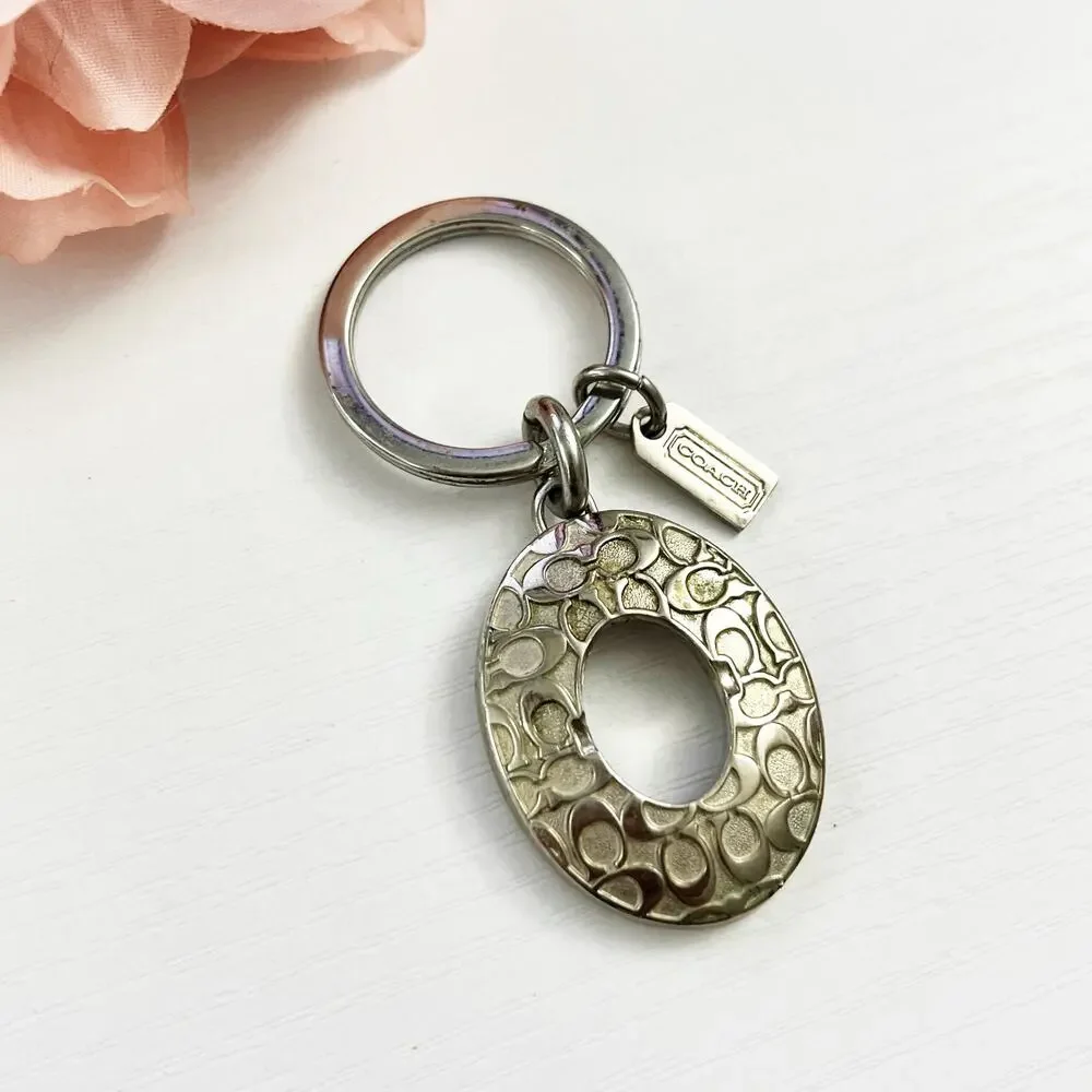 Coach Silver Tone Oval Signature C Keychain